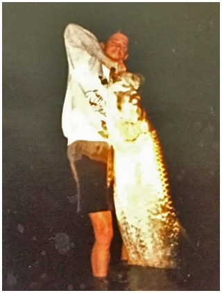 Captain Corey holding  a large tarpon he caught in Daytona Beach